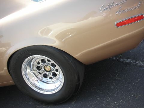 2004 Ford Crown Victoria - Close-up of the rear wheel and "California Special" badging on a vintage Ford Mustang.