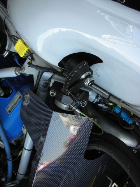 2004 Ford Crown Victoria - A detailed view of a white vehicle's internal mechanics, carbon fiber elements and blue wiring harnesses.