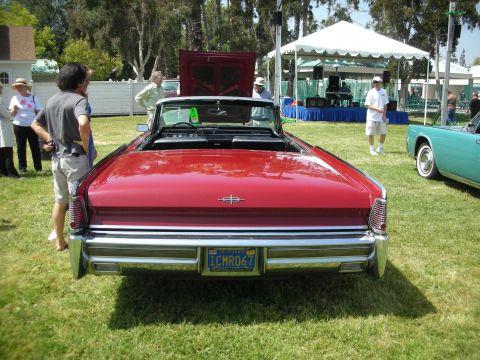 2004 Ford Crown Victoria - A red 1967 Lincoln Continental convertible is parked on the grass at an outdoor event, with another classic car visible to the right.