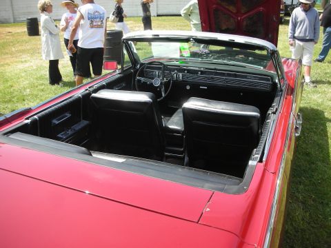 2004 Ford Crown Victoria - Interior view of a red convertible with black upholstery and dashboard.