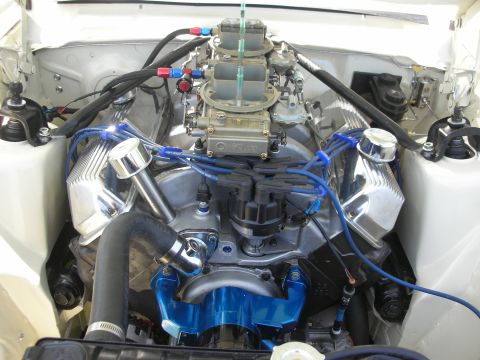 2004 Ford Crown Victoria - Close-up view of a modified engine bay dual carburetors and chrome valve covers.