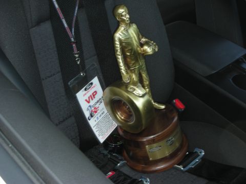 2004 Ford Crown Victoria - A trophy and a VIP pass are placed on the seat of a car.