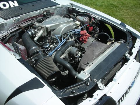 2004 Ford Crown Victoria - Close-up of a modified Ford V8 engine bay, showing the intake and cooling system components.
