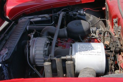 1992 Ford Taurus - Close-up of a supercharged engine, a handwritten sign detailing its components and rarity.