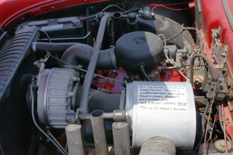 1992 Ford Taurus - Close-up of an engine bay, a supercharger and a note detailing engine components.