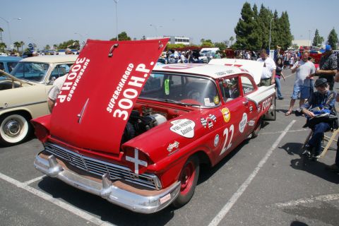 1992 Ford Taurus - A red and white race car with its hood open, displaying "SUPERCHARGED 300 H.P." and the number 22 on its side.