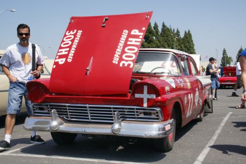1992 Ford Taurus - A vintage red and white Ford Fairlane 500 Skyliner is displayed with its hood open at an outdoor event.