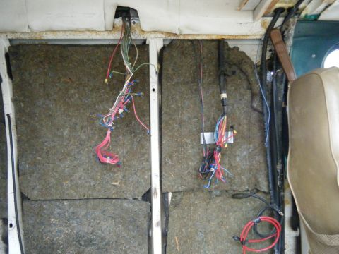 1981 Ford E350 - The interior of a van is shown with insulation removed and electrical wiring exposed.