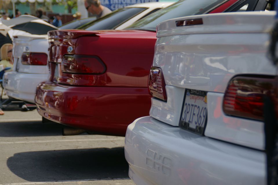 White sedan's rear end, showing a spoiler and license plate 3PTF369
