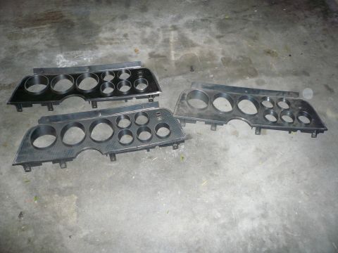 1975 Ford Ranchero - Several car dashboard instrument panels are shown, likely for parts or restoration projects.
