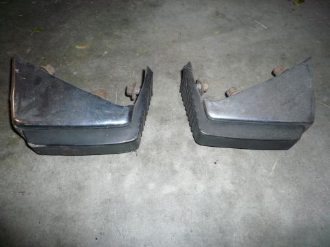 1975 Ford Ranchero - A pair of black bumperettes are shown against a concrete background.