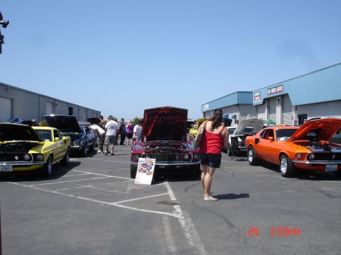 1978 Ford Mustang II - A collection of vintage automobiles are displayed outdoors, with people milling around and examining the vehicles.