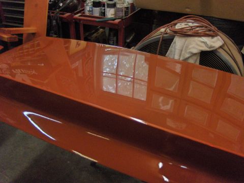 1980 Chevrolet Camaro - A freshly painted car part sits in a workshop, reflecting the environment.
