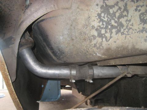 1976 Ford F-250 - The underside of a vehicle shows a section of the exhaust system and a fuel tank.