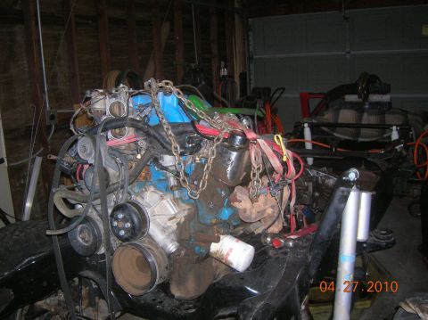 1985 Ford Bronco - An engine assembly, possibly for a Ford Bronco, is shown with various components and chains attached, dated April 27, 2010.