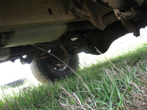 1978 Ford Bronco - Undercarriage view showing the rear axle and suspension components of a vehicle.
