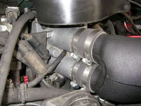 1990 Ford Bronco - Close-up view of an engine's intake manifold and associated hoses.