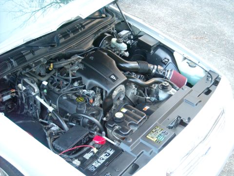 2003 Ford Crown Victoria - The engine bay of a 2003 Ford Crown Victoria, an aftermarket air intake system and a clean engine compartment.