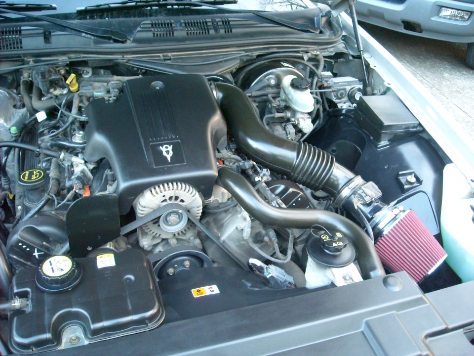2003 Ford Crown Victoria engine bay with V8 engine cover and aftermarket air filter