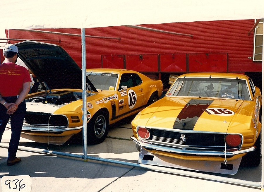 Front view of yellow 1970 Mustang race car with black stripe and number 16