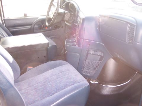 2006 Chevrolet Corvette - The interior of a van is shown, the driver's seat and dashboard area.