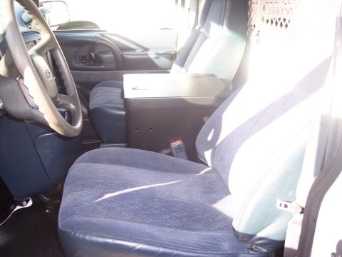 2006 Chevrolet Corvette - Interior view of van seats and dashboard with center console.