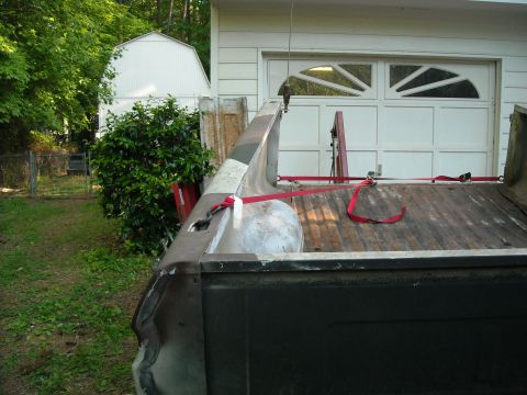 1979 Ford F-150 - The rear of a 1979 Ford F-150 pickup truck bed, secured with red tie-down straps.