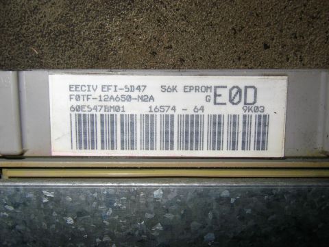 1990 Ford Bronco - Close-up of an electronic control unit (ECU) with part numbers and a barcode visible.