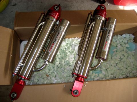 1996 Ford Bronco - Two new RaceRunner shock absorbers are shown in a cardboard box, ready for installation.