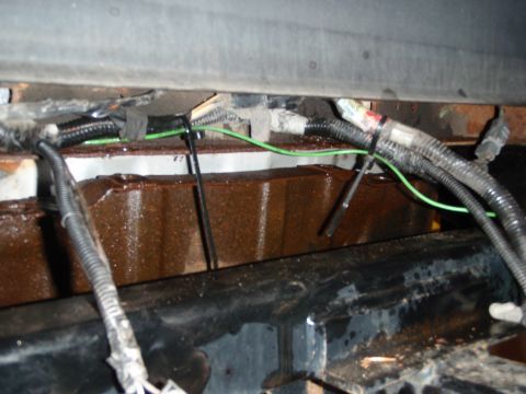 1995 Ford Bronco - Close-up view of the vehicle's rear suspension system, showing wiring and structural elements.