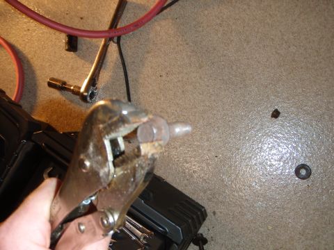 1995 Ford Bronco - Vise grips are used to hold a bolt during a repair or maintenance task.