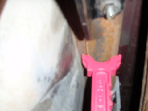 1995 Ford Bronco - A pink suspension part is visible near rusty metal components.
