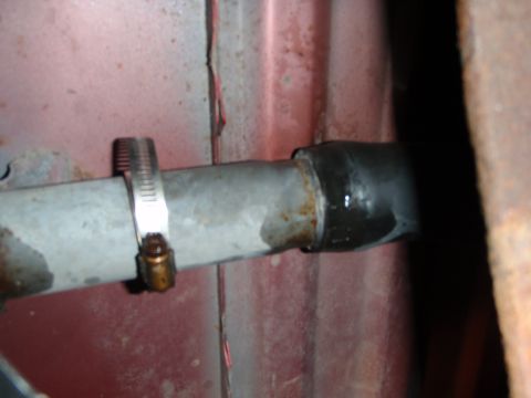 1995 Ford Bronco - Close-up of a hose clamp on a metal pipe with a rubber hose attached.