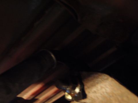 1995 Ford Bronco - Underside view of a vehicle's suspension system, focusing on a single part.