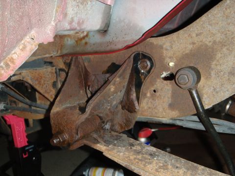 1995 Ford Bronco - Close-up view of heavily rusted vehicle suspension components, suggesting significant wear and tear.
