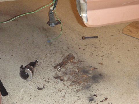 1995 Ford Bronco - A disassembled vehicle part and tools lie on a concrete floor next to a section of a pink vehicle body panel.