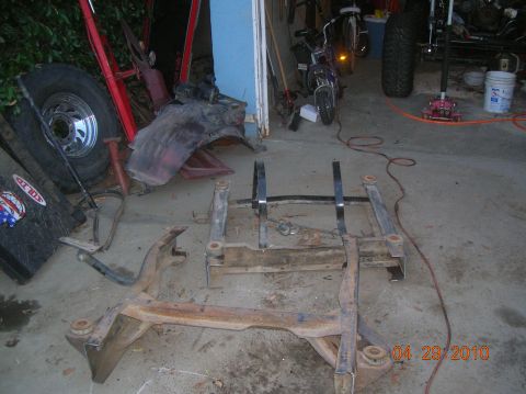 1985 Ford Bronco - Vehicle frame components and a tire are visible on a concrete floor with a date stamp of 04.29.2010.