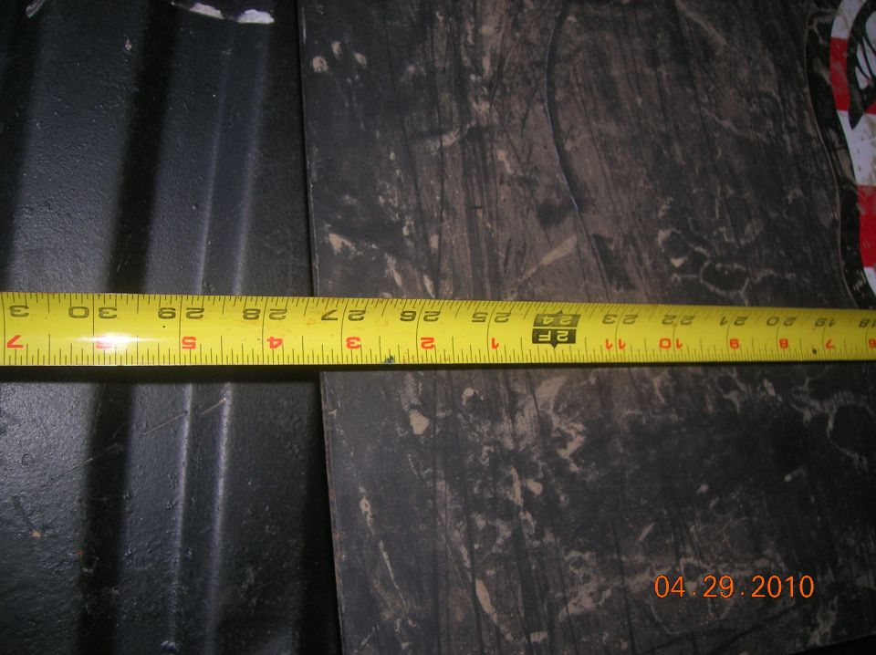 Yellow measuring tape showing about 29 inches on a dark, textured surface. Date stamp reads 04.29.2010