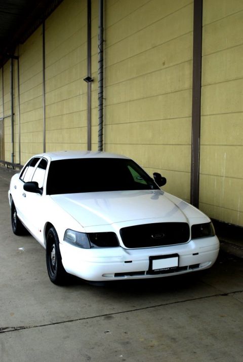 1998 Ford Crown Victoria - A white 1998 Ford Crown Victoria is shown from the front 3/4 angle, parked outdoors.