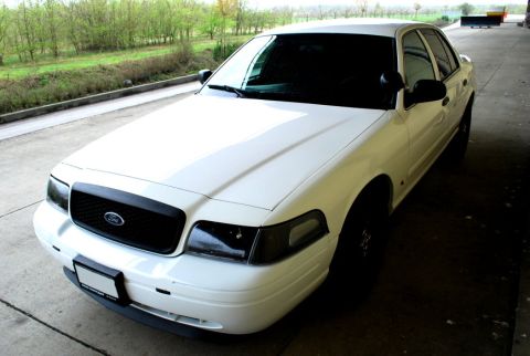 1998 Ford Crown Victoria - This 1998 Ford Crown Victoria is captured from a three-quarter front angle, its clean white exterior.