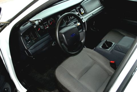 1998 Ford Crown Victoria - Interior view of a 1998 Ford Crown Victoria, highlighting the dashboard and seating.