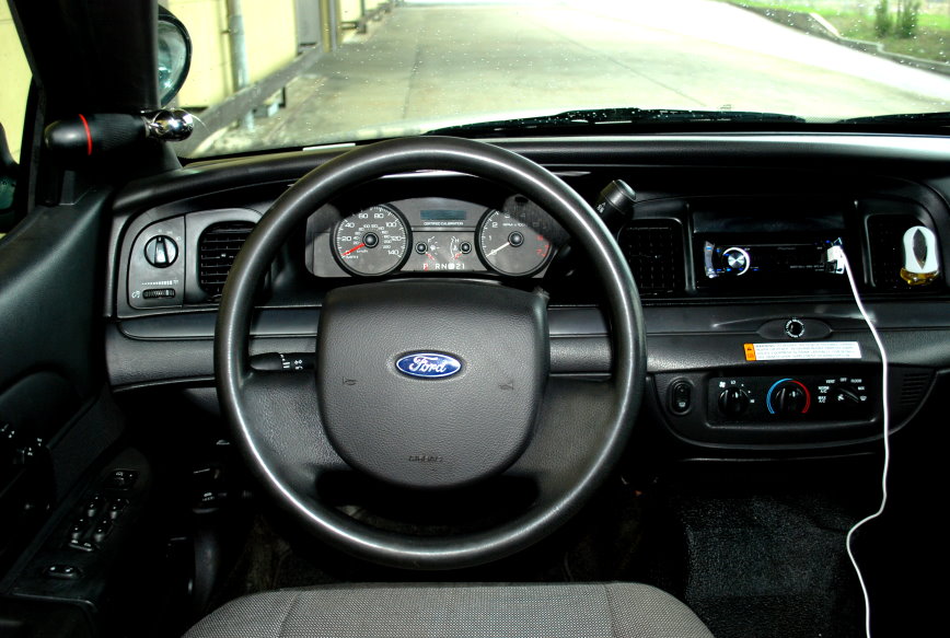Interior view of a 1998 Ford Crown Victoria, showing the dashboard, steering wheel, and center console