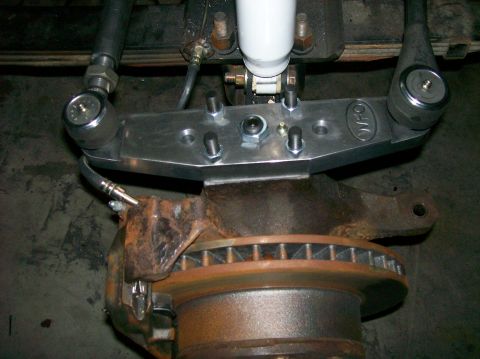 1989 Ford Bronco - Close-up of a custom steering linkage and brake assembly, possibly for an off-road vehicle.