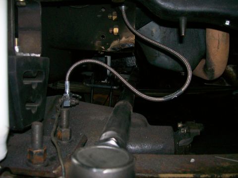 1989 Ford Bronco - Undercarriage view shows a braided brake line connected to the suspension system.