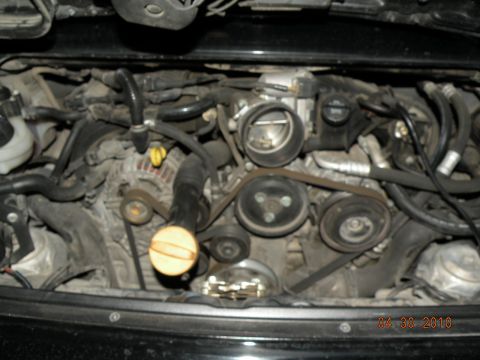 2000 Porsche Carrera - Close-up view of a car's engine compartment, showing various mechanical components.