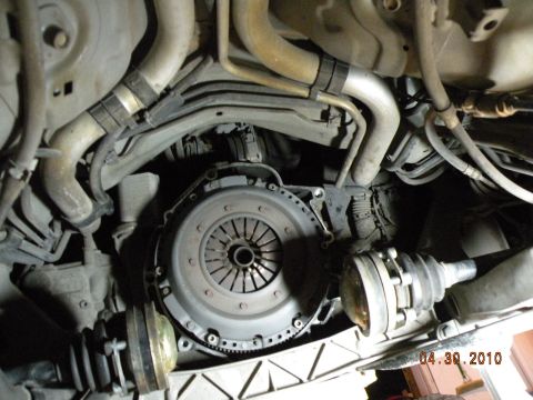 2000 Porsche Carrera - Close-up view of automotive clutch and driveshaft components, with visible hoses and pipes.