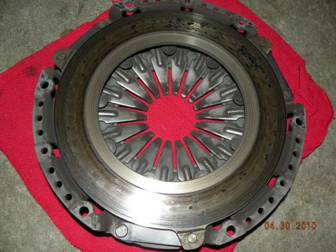 2000 Porsche Carrera - Close-up of a clutch pressure plate, possibly for a Porsche Carrera, resting on a red cloth.