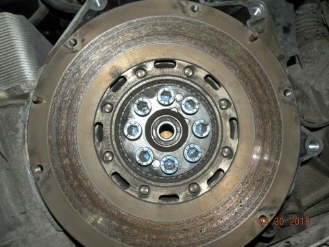 2000 Porsche Carrera - Clutch flywheel and pressure plate bolts visible in this close-up mechanical part photo.