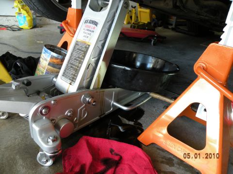 2000 Porsche Carrera - Garage scene with car maintenance equipment including a jack and jack stands.
