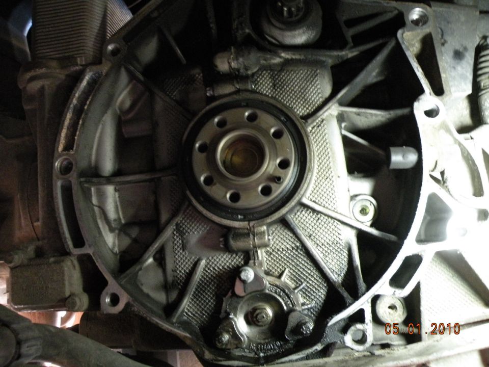 Close-up of a metal engine component with a circular flange and visible bolts